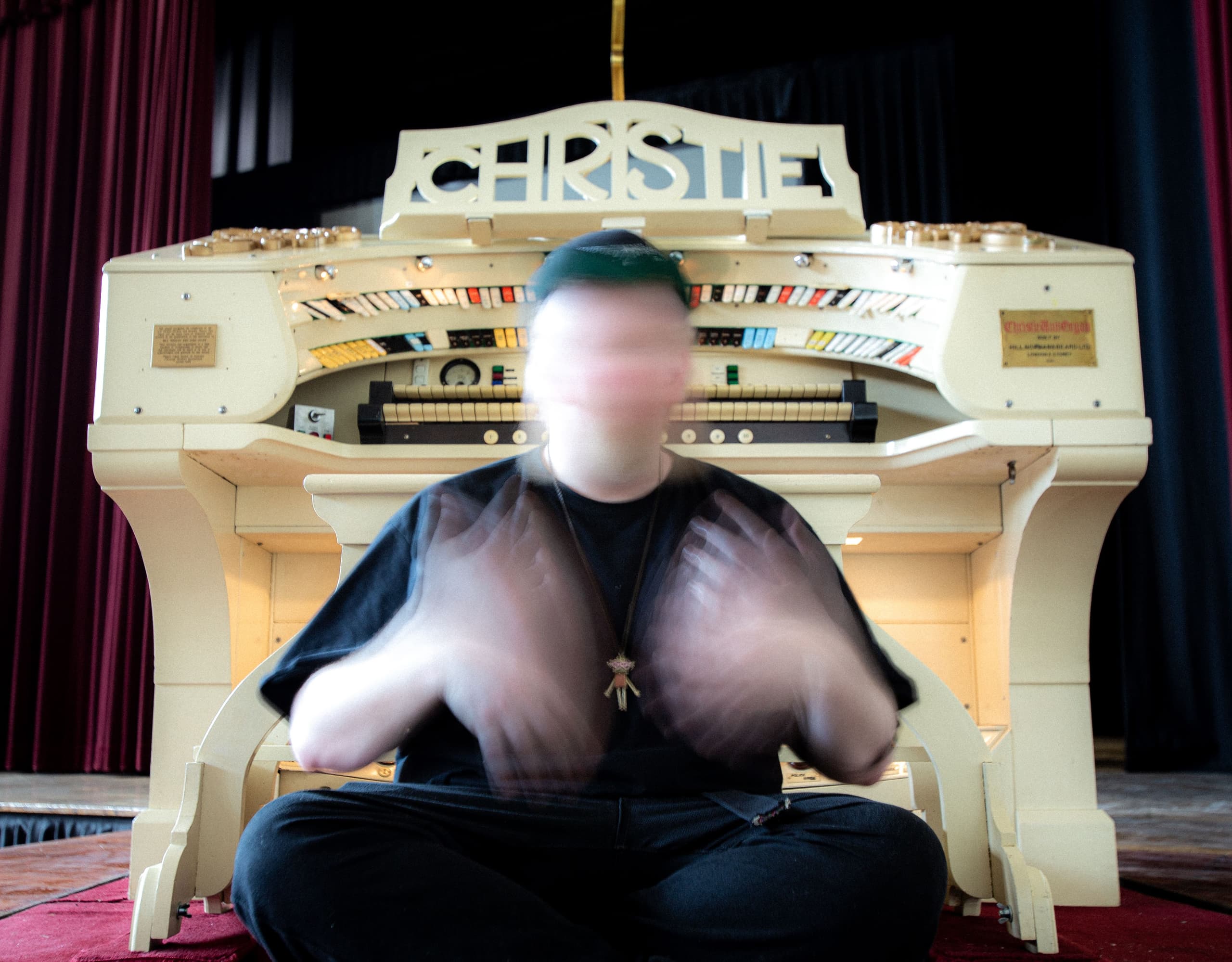 A man sitting in front of an old organ