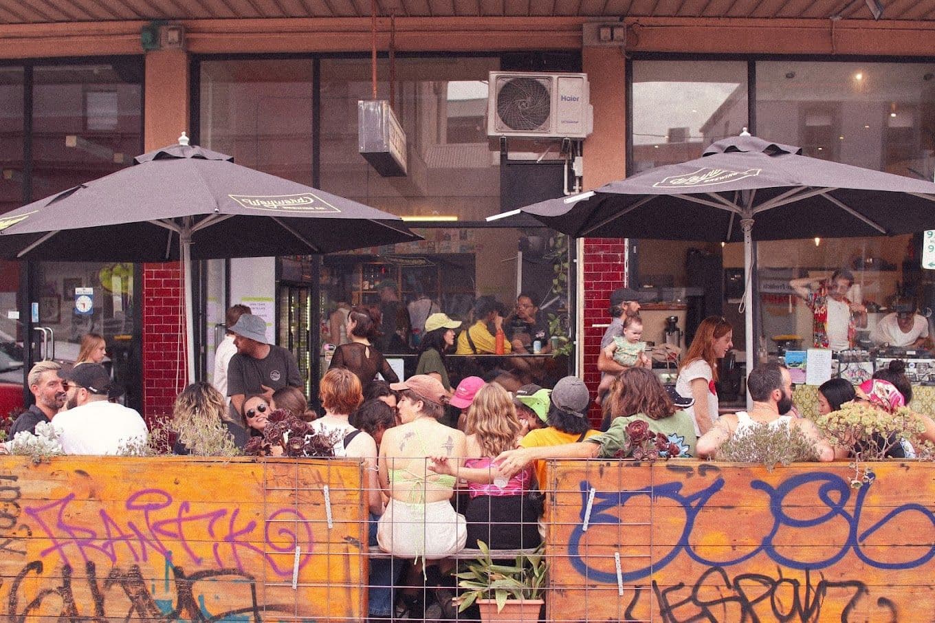 A group of people sitting outside a pub