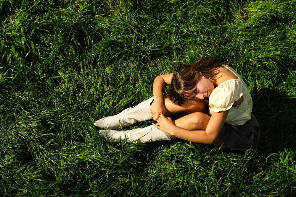 A woman sitting in the grass